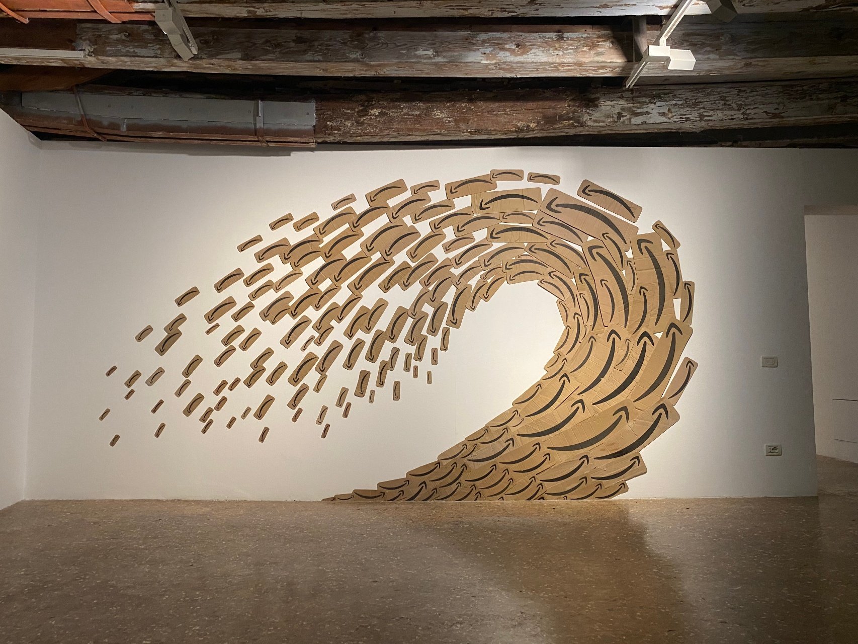 Tina Zimmermann / Palazzo Mora, Amazon Tsunami, 2021, Site-specific wall installation made from hundreds of cardboard pieces ripped from Amazon shipping boxes