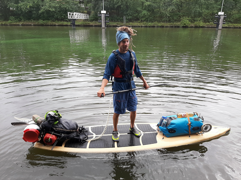 Josua Wechsler on his SUP board across the river Rhine l Feb 2021 l Photo Wouter Zweers