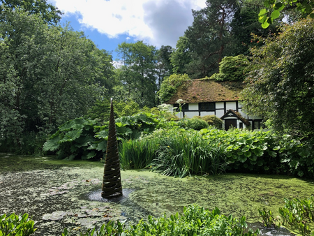Giles Rayer, "Scylla" in front of Black & White Cottage. Images courtesy of The Hannah Peschar Sculpture Garden.