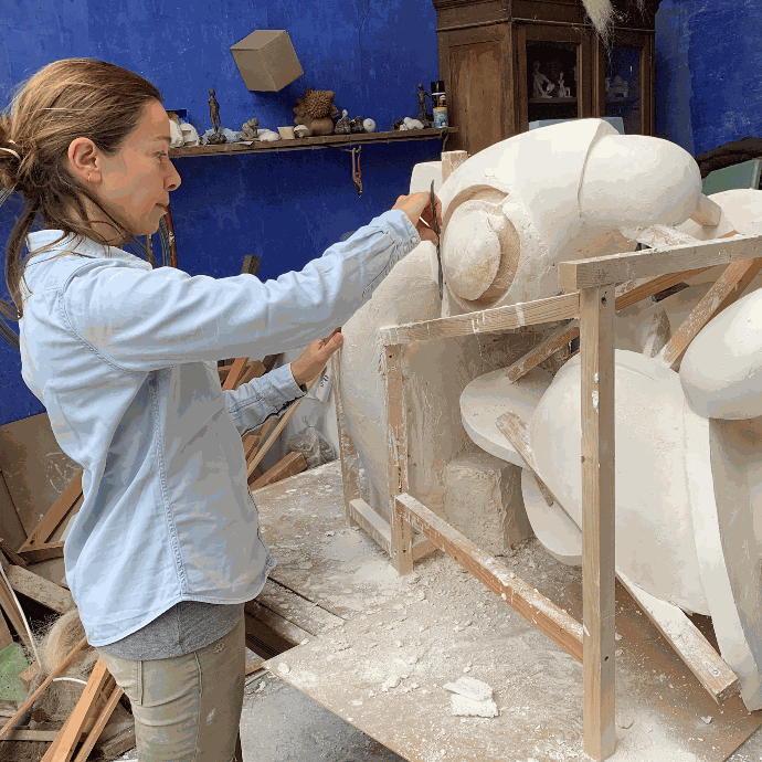 Artist Chantal Grard working in her studio on "Concubinus" - Plaster and Wood - 2023.